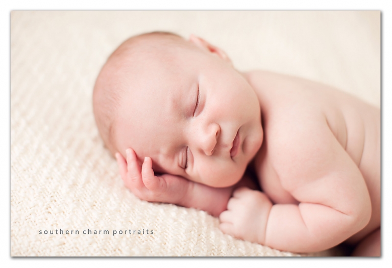 sweet newborn image on cream blanket little fingers and sleeping
