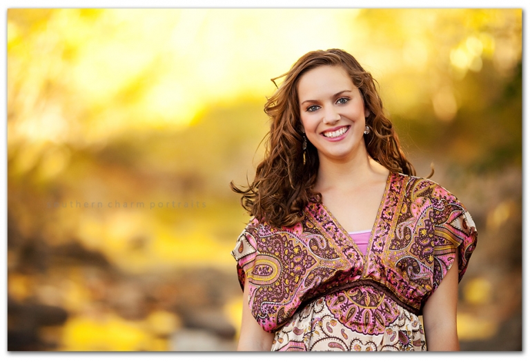 young lady wading in creek to get some beautiful senior portraits