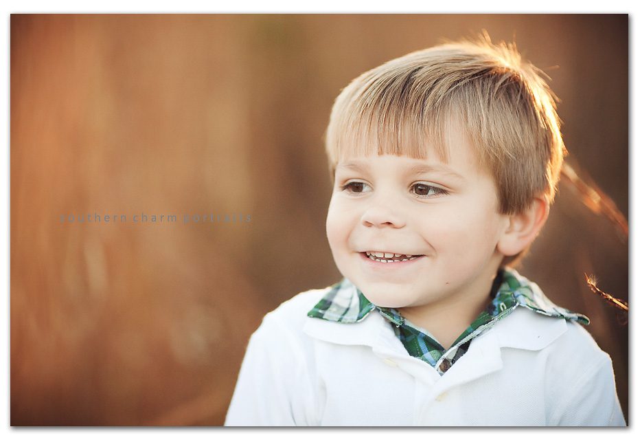 boy looking off to the side and smiling
