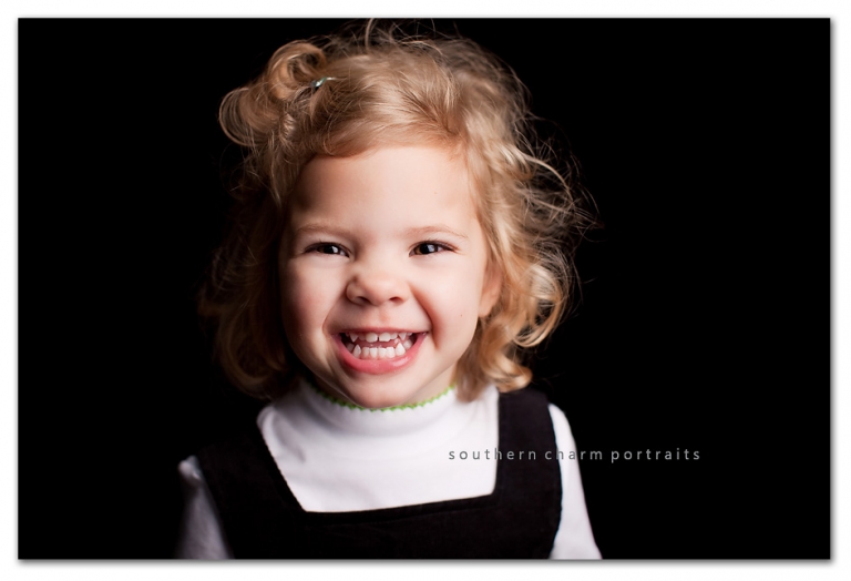 this little lady has big brown eyes and some beautiful curls. isn't her smile contagious??