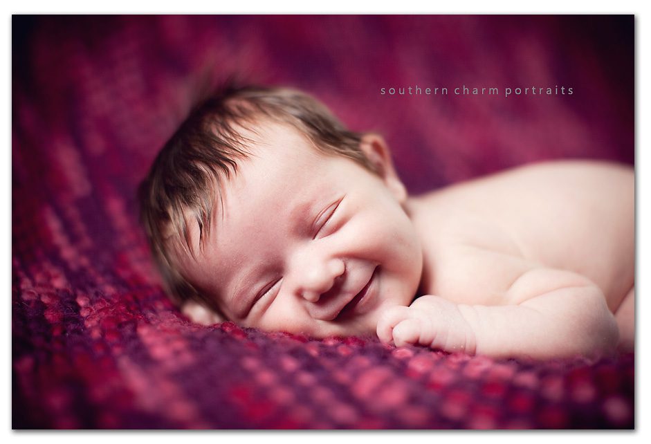 newborn 2 weeks old smiling in sleep