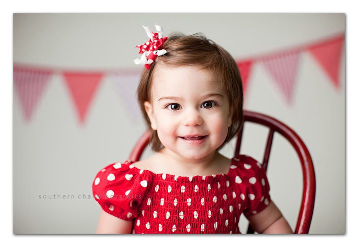 white backdrop with red and white bunting banner draped across it