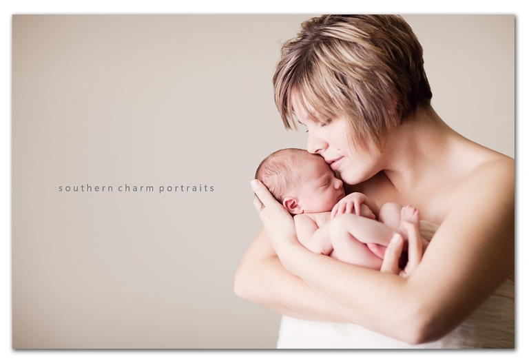 mother holding newborn baby showing love and affection