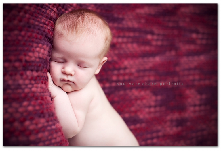 baby sleeping on pink and purple blanket just a few weeks old