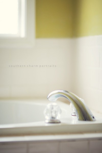 shot of bathroom tub and window- white tile with green walls
