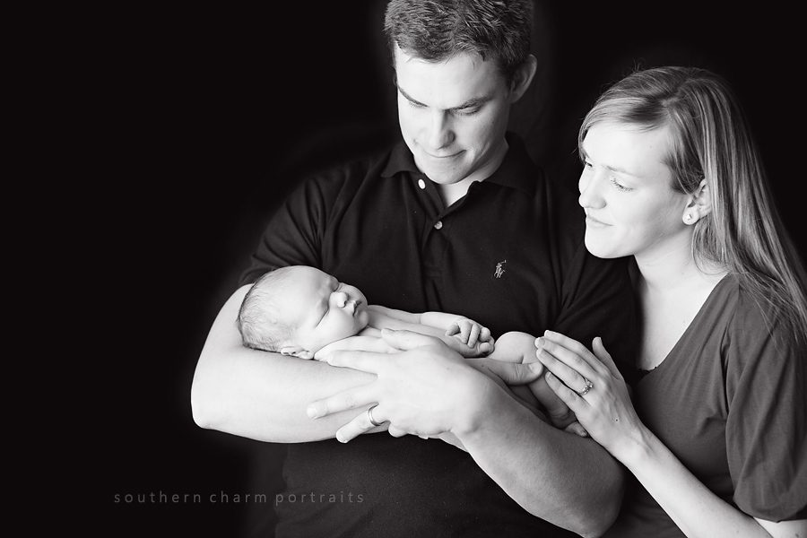 family of three with new baby boy