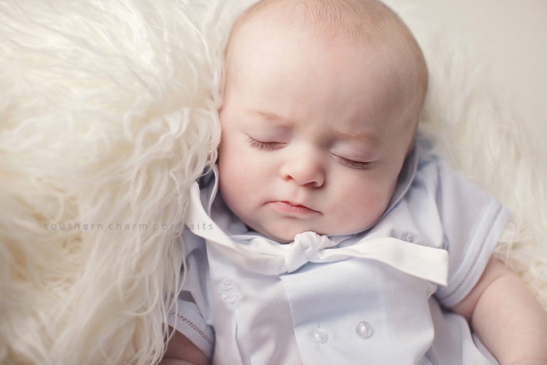 baby sleeping in crate during portrait session