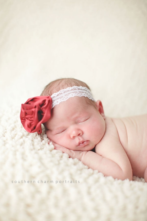 baby with headband on blanket sleeping
