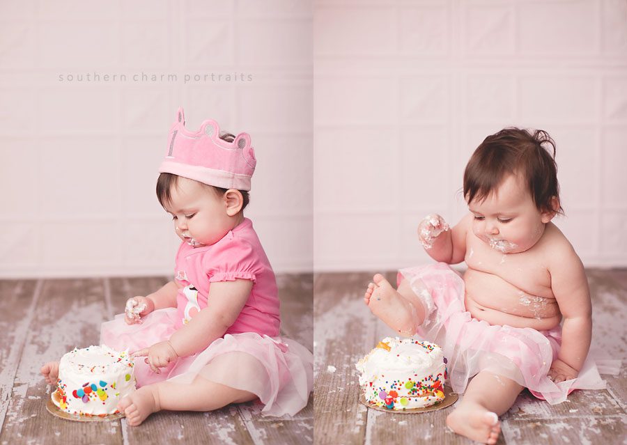 baby girl eating smash cake for first birthday