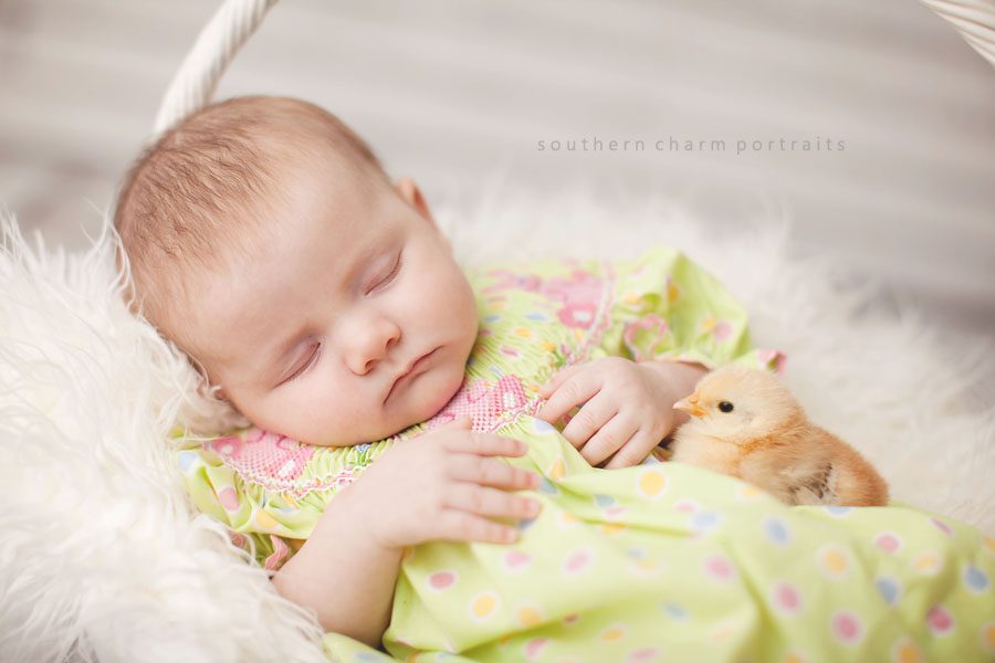 baby sleeping with baby chick
