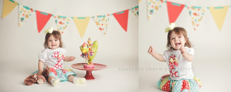 little girl with first birthday outfit and banner