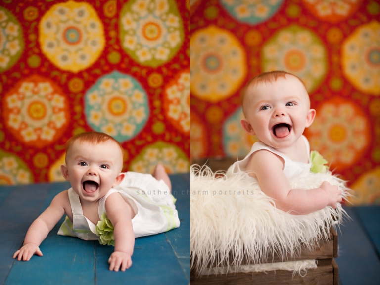 baby in crate smiling on blue wood floor