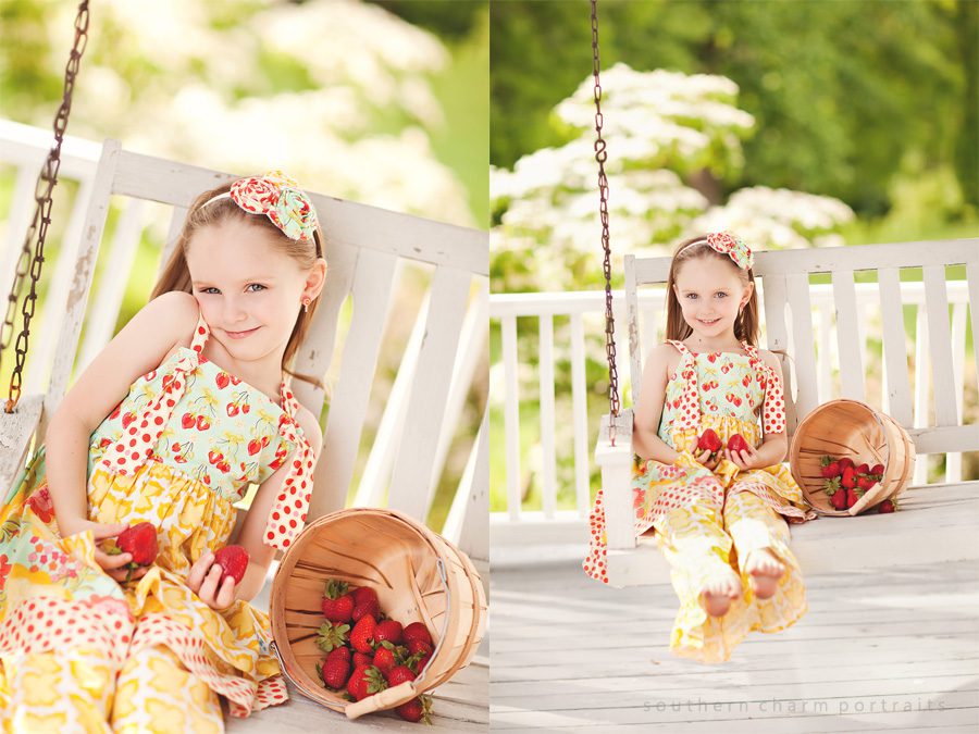 little girl on swing with strawberries in basket