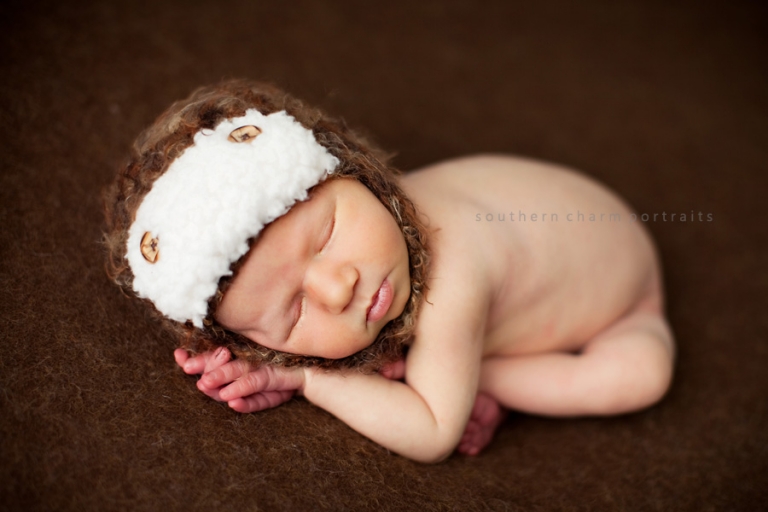 baby sleeping with pilot brown hat