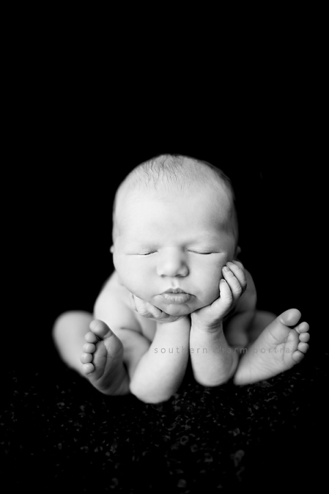 babie with head propped up on hands sleeping